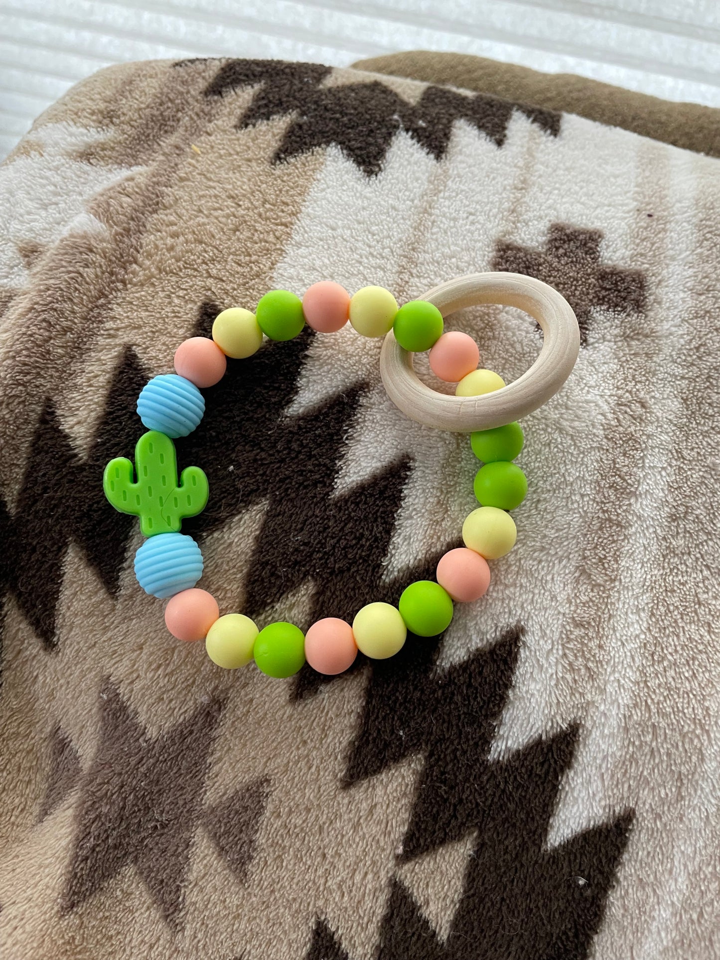 green and blue baby teether